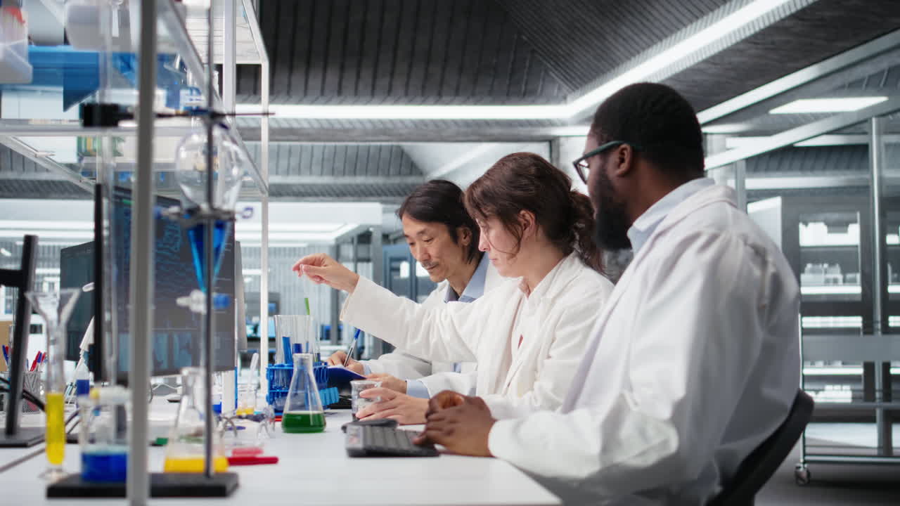 Vertical video Senior researcher records observations from experiment done by coworkers