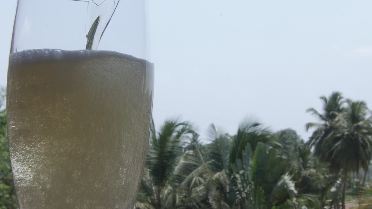 A shot of pouring alcohol in the glass