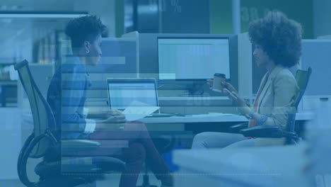animation of diagrams and data processing over biracial female colleagues talking in office