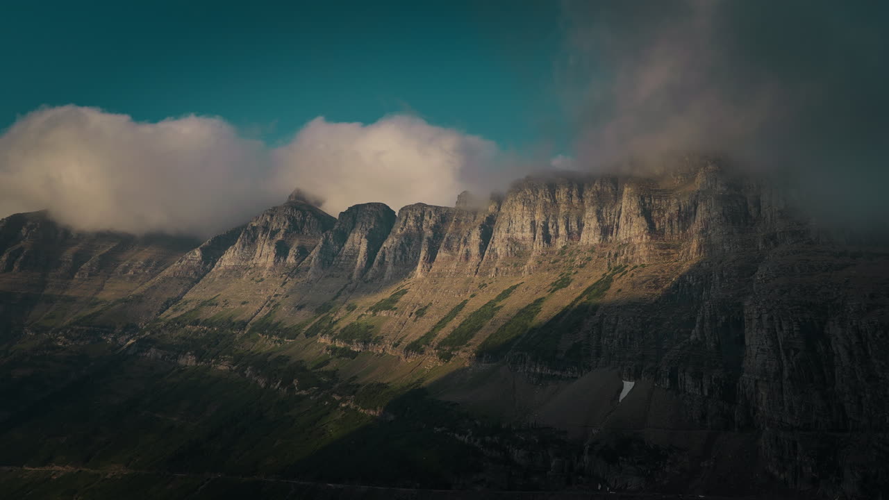 Majestic mountains in Montana with clouds and sunlight creating drama