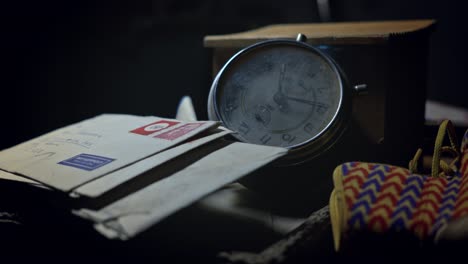 an old alarm clock, a baby shoe and letters