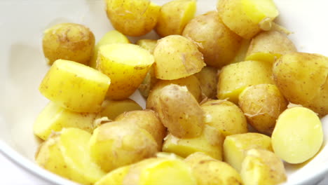 potatoes rotating in a white bowl