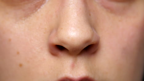 person flares their nostrils