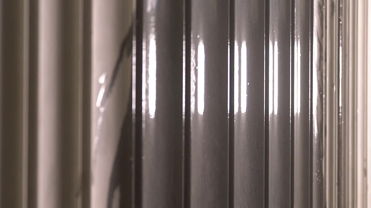 Clean Water Splashing On The Corrugated Surface Of A Marble Stone - close up slowmo