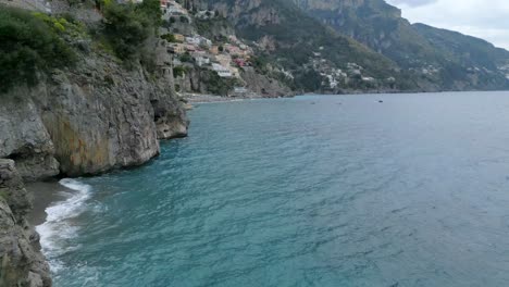 Drone-reveal-of-Positano-Italy-Amalfi-town-with-ocean-and-beach