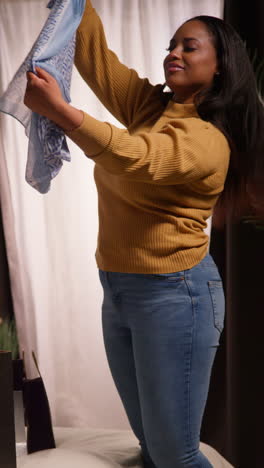 woman trying on a scarf in a clothing store