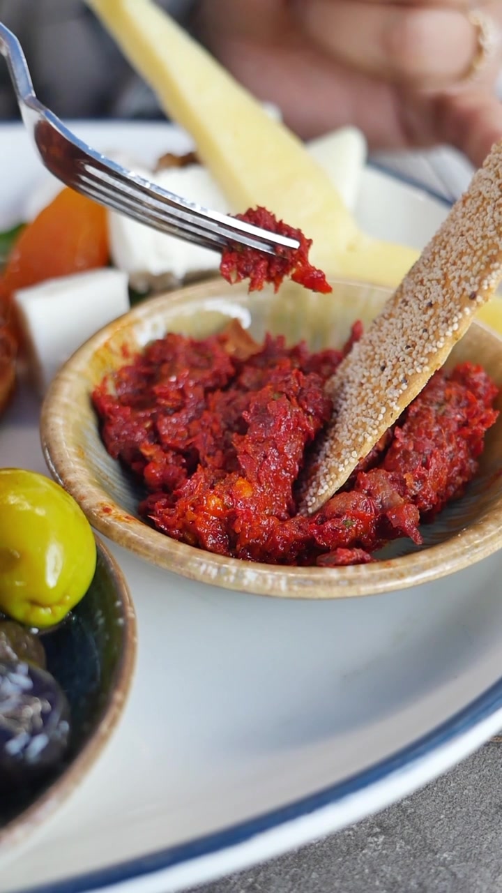 Person Using Fork to Eat Spicy Red Pepper Spread