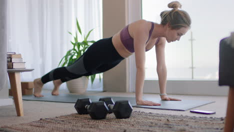 healthy woman exercising at home practicing push ups in living room enjoying morning fitness workout