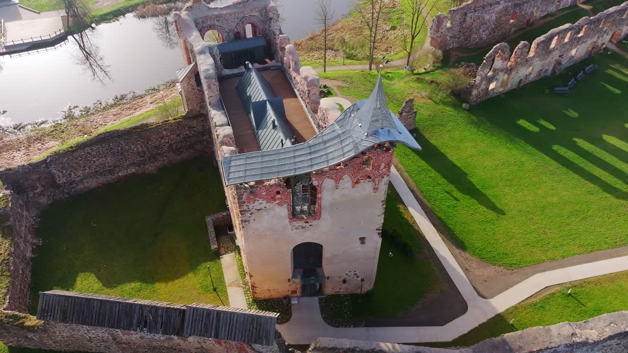 Medieval Dobele Castle stands amid spring greenery on ancient hilltop site