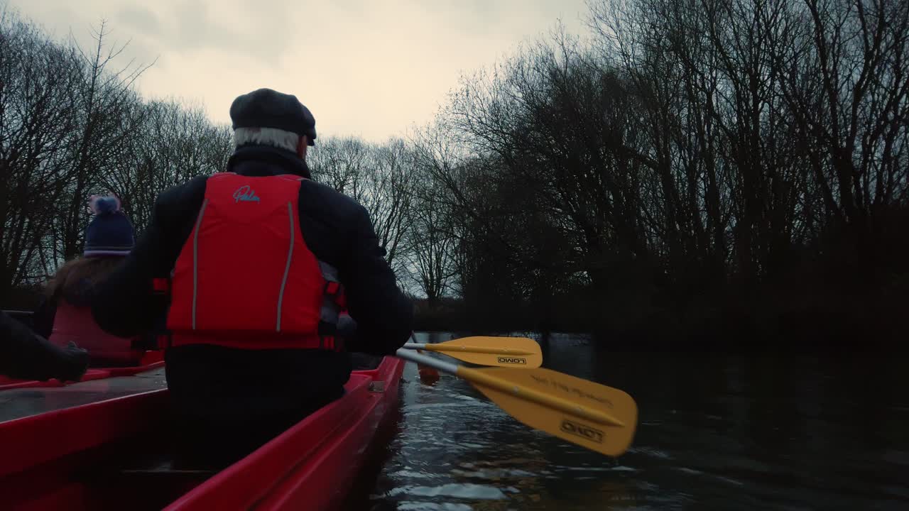 Elderly old man paddle canoeing on water in kayak during sunset sunrise 2