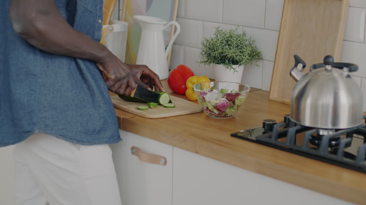 Person Chopping Vegetables in a Kitchen