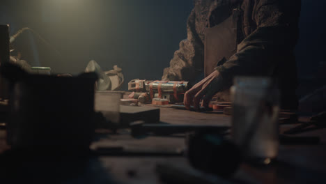 a man in the dark workshop unveil a homemade bomb
