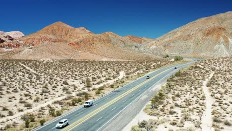 Highway-14-follows-the-historic-Midland-Trail-through-the-Mohave-Desert's-rugged-landscape---ascending-aerial-view