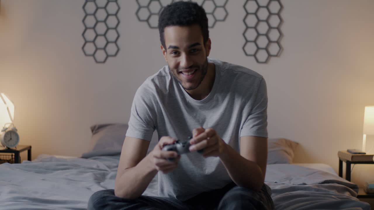 Man Playing Video Games in His Bedroom