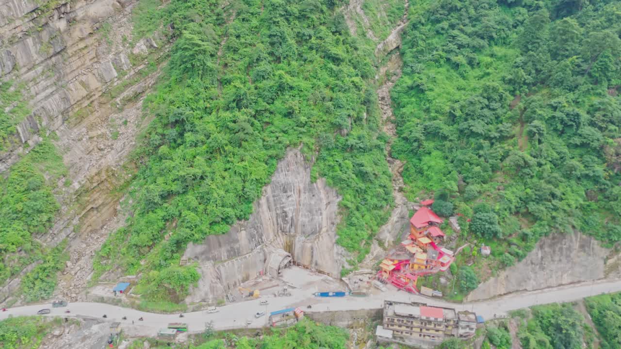 Aerial drone footage of the famous Siddhababa Temple in Tansen Palpa, Nepal, located on a scenic hillside with winding mountain roads and stunning natural surroundings