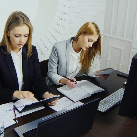 young employees check documents in the workplace