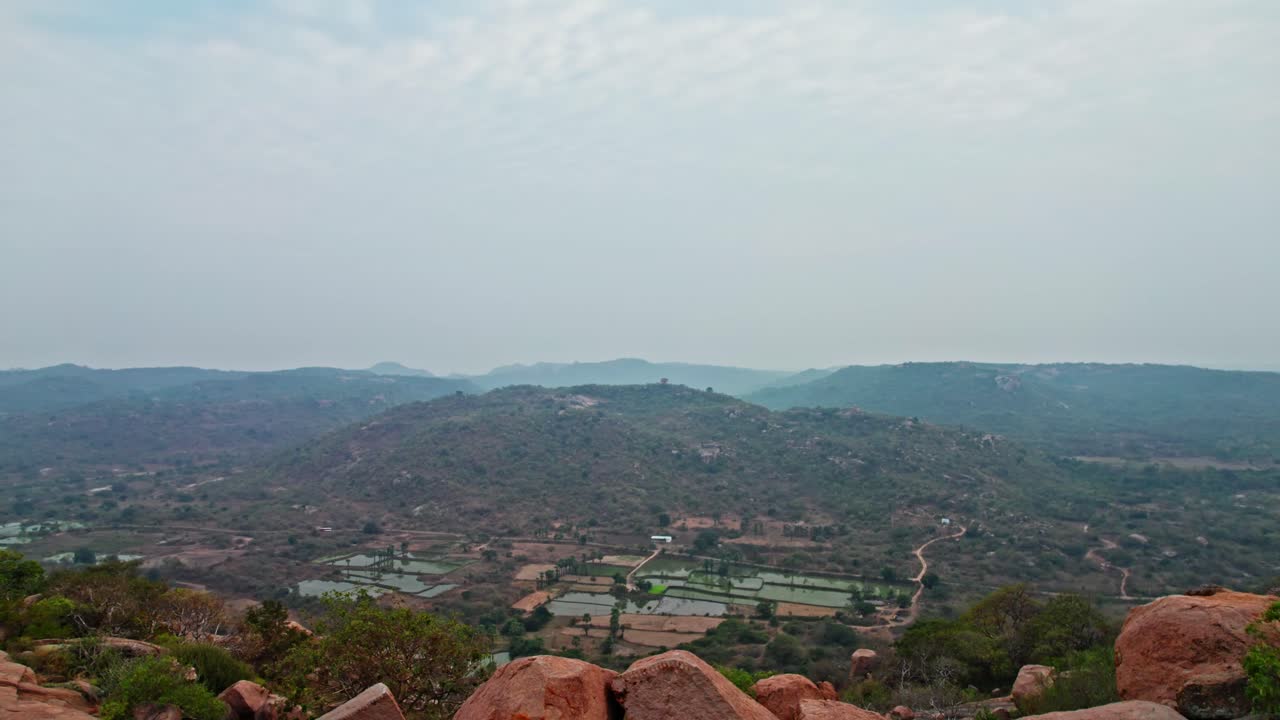 Big hill Mountain with crop field lands and sky at rachakonda fort, telangana, india. day time, moving up shot, drone shot, 4k.