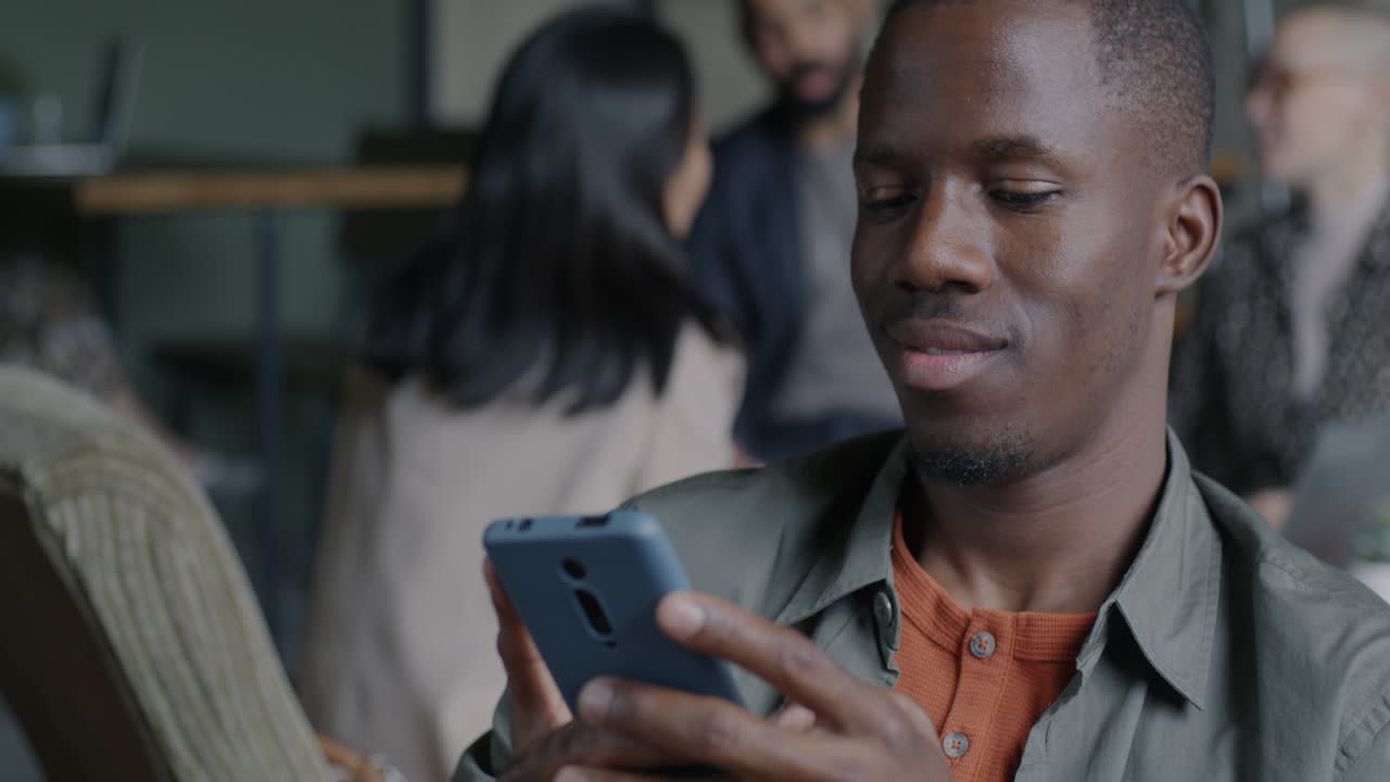 Man looking at his smartphone in a modern office