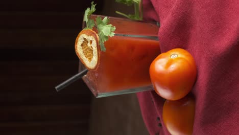 Portrait-footage-of-a-bloody-mary-cocktail-rotating-with-garnish