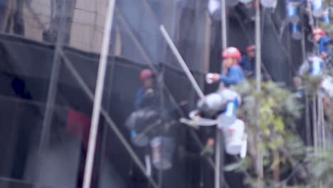 workers repairing windows on a skyscraper