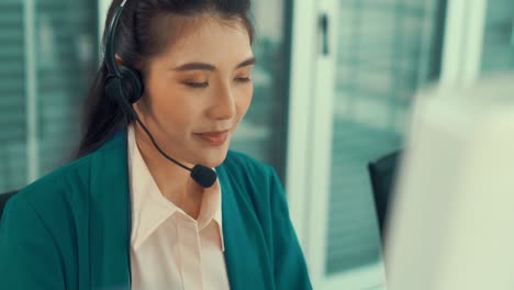 businesswoman wearing headset working actively in office