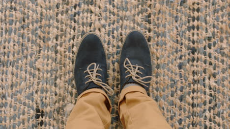 top view man wearing shoes enjoying stylish footware standing on carpet rug