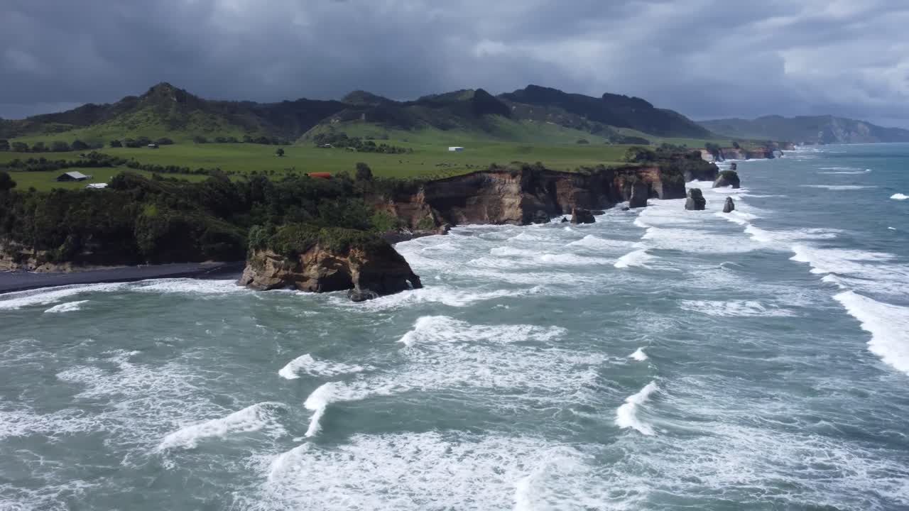 Aerial View of Dramatic Coastline with Waves Crashing on Rocks