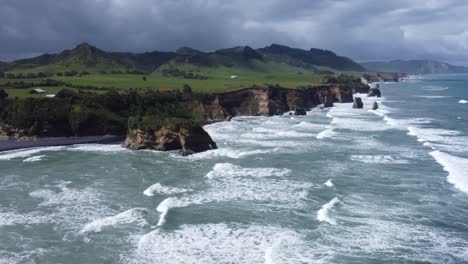 aerial view of dramatic coastline with waves crashing on rocks