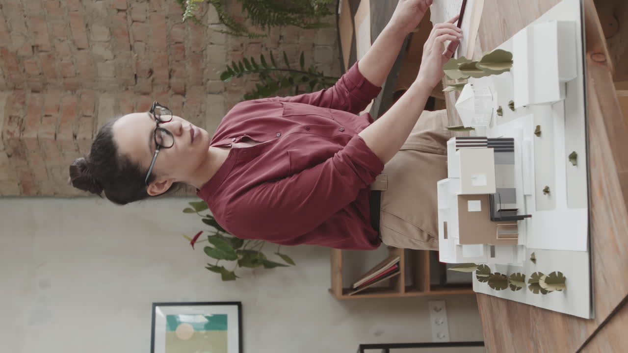 Successful Female Architect Working On House Design