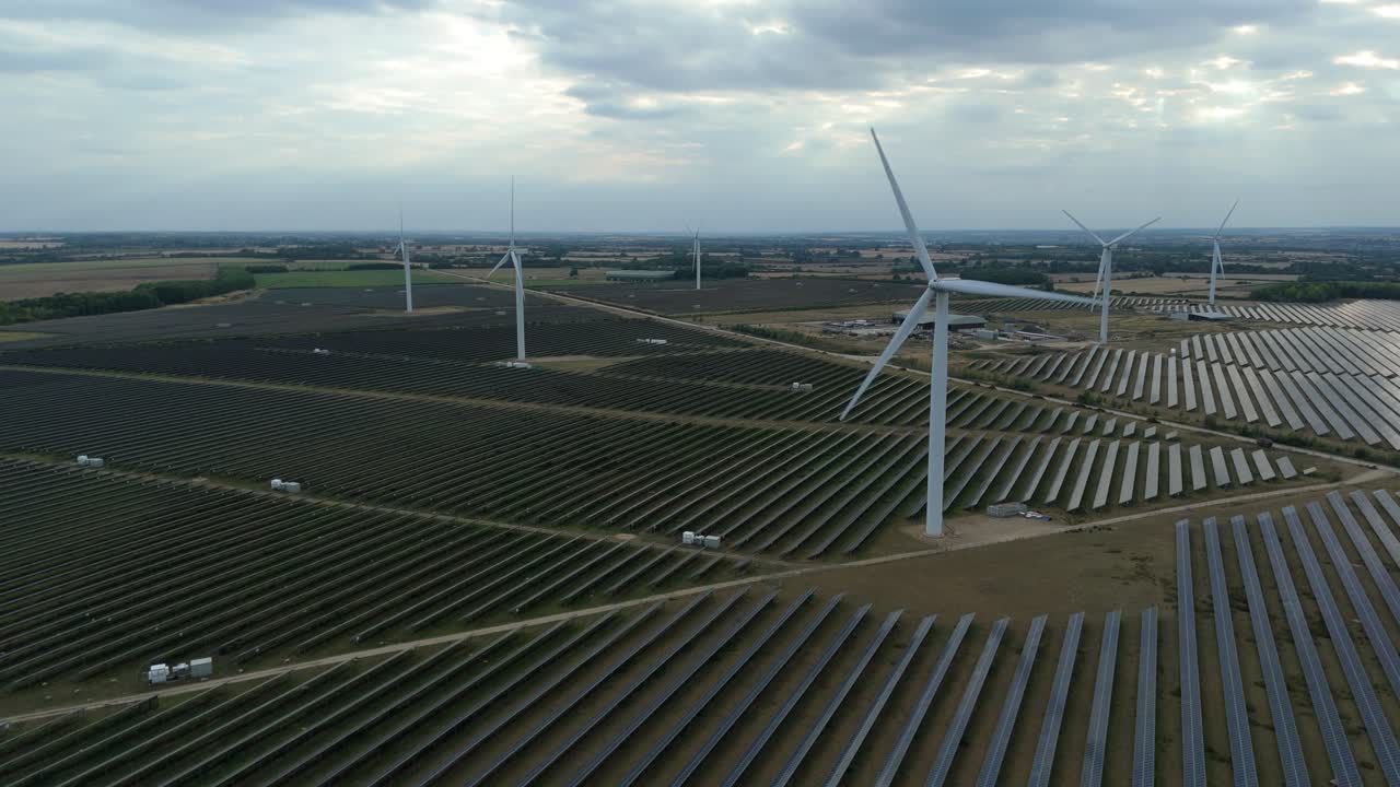Drone shot of solar panels and wind turbines generating green electricity in Wellingborough United Kingdom