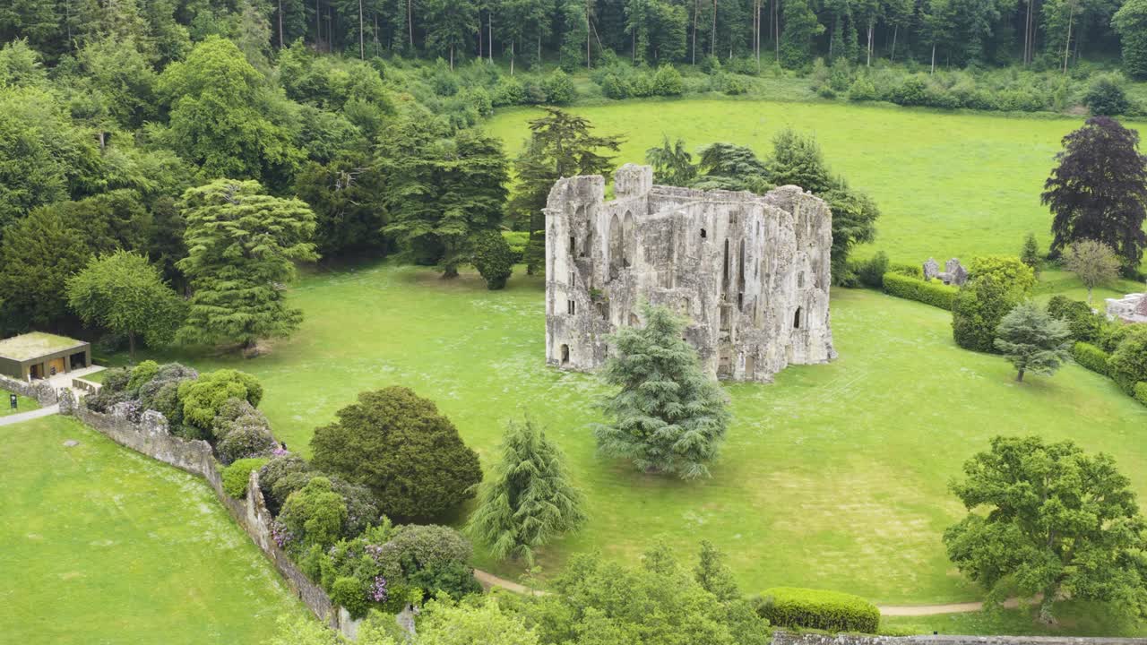 View of ancient Wardour Castle in bright woodland setting, UK heritage site