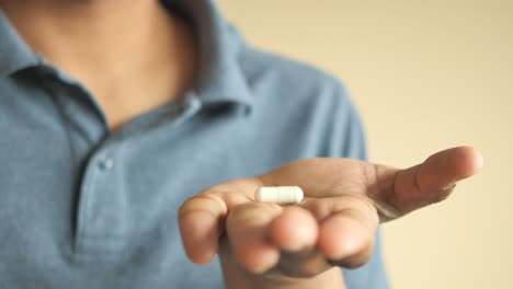 person holding a pill