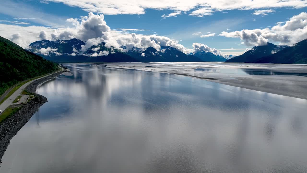 Alaskan Landscape with Mountains, Road, and Reflective Water