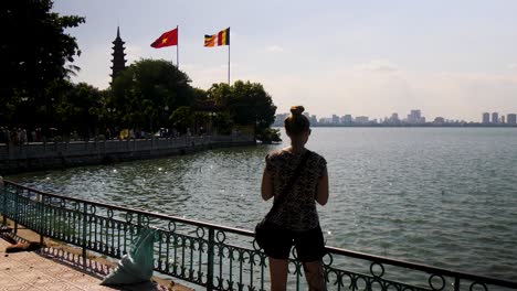 Young-female-tourist-on-vacation-in-Vietnam-capturing-the-sights-on-her-smartphone