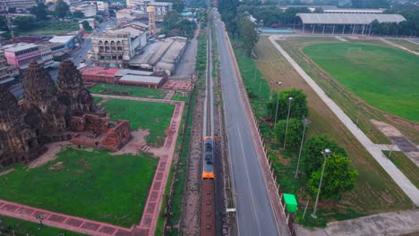 aerial view of a town in thailand with train passing through