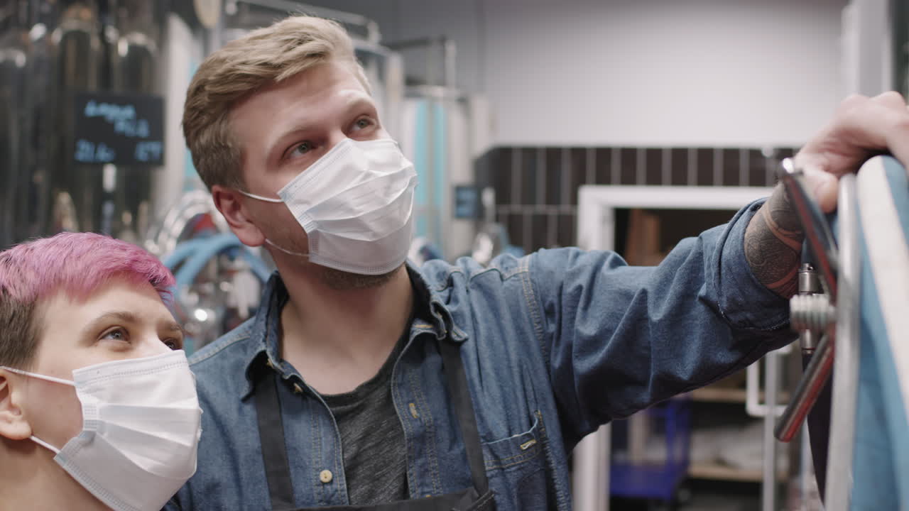 Brewery Experts Examining Beer Production Process