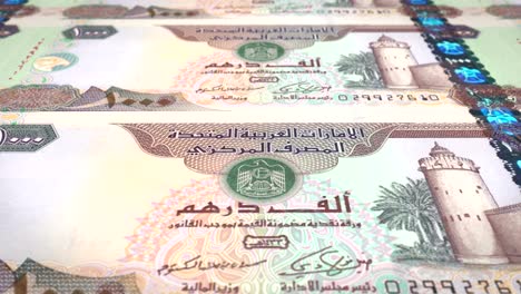 banknotes of one thousand dirhams arabs of the bank of the arab emirates rolling on screen, coins of the world, cash money, loop