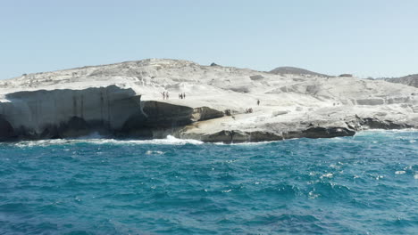 Aerial-View-of-Sarakiniko-Beach-with-Waves-crashing-into-rocks-in-Milos,-Greece