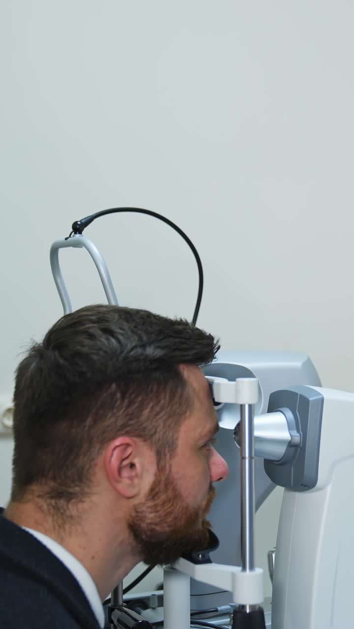 Special equipment in ophthalmology clinic for vision correction. Special corrective technologically up to date equipment. Man`s portrait in clinic. Vertical video