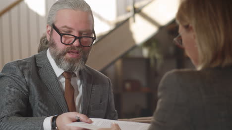 senior businessman discussing agreement with coworker in restaurant