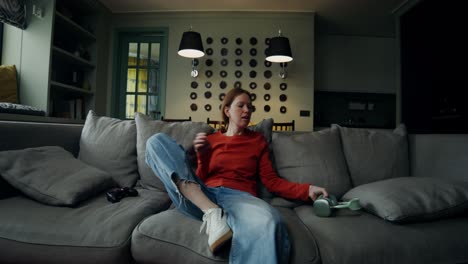 woman playing video games on a couch at home