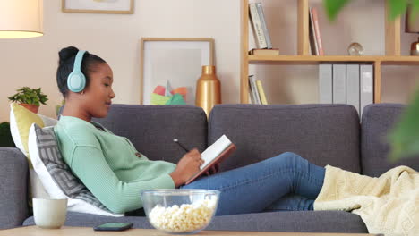 black student streaming an audio book while making