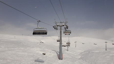 timelapse - 6 person ski lift ride with the gondola lift intersection in the gudauri ski resort in georgia during winter on the month of december