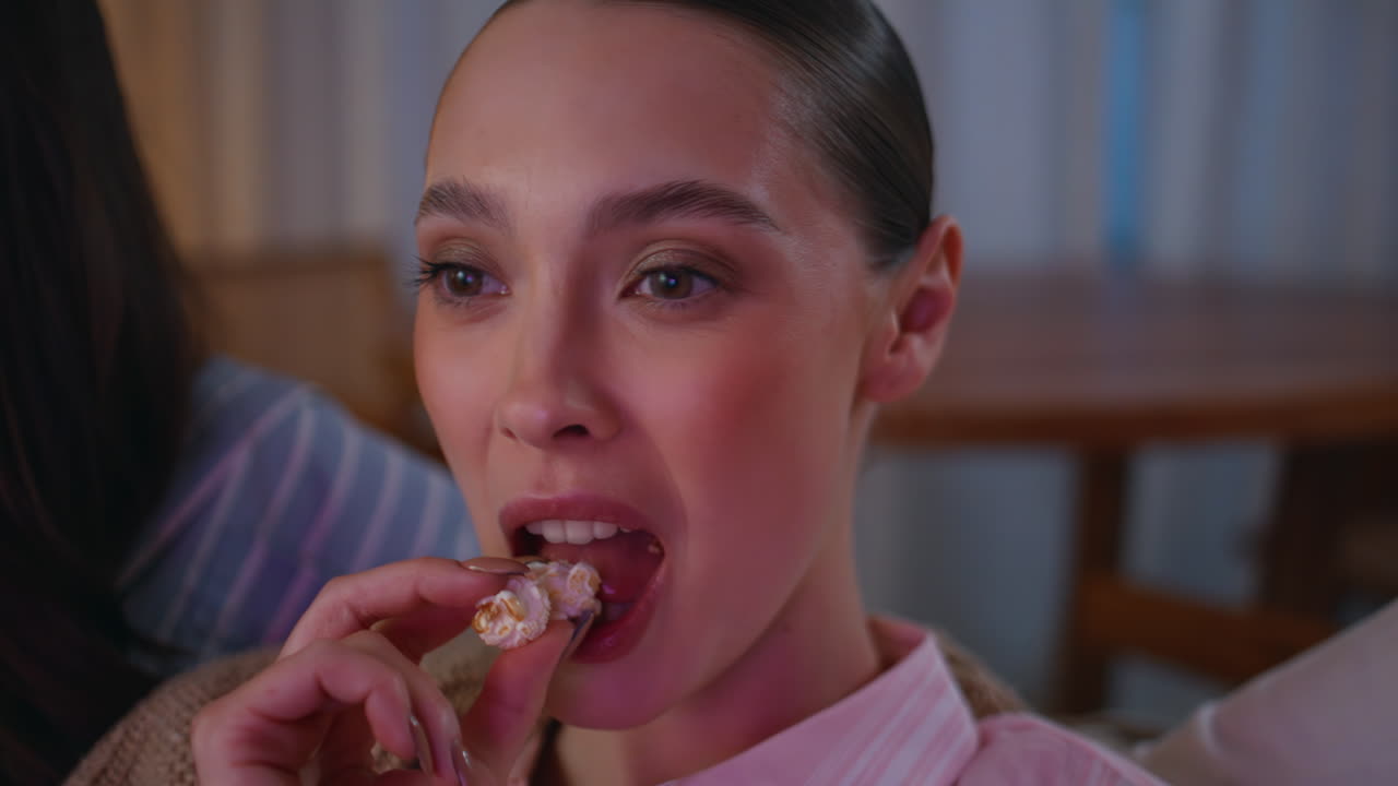 Woman watching television friends feeling relaxed at evening home closeup