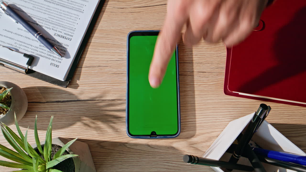 Mockup mobile phone lying on well-organized office desk closeup top view
