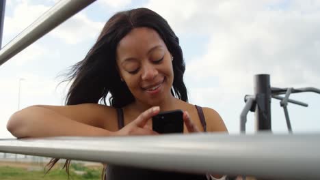 happy disabled woman using mobile phone in the park 4k