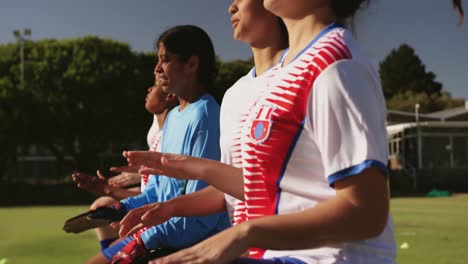 Female-soccer-team-running-on-the-place-on-soccer-field.-4k