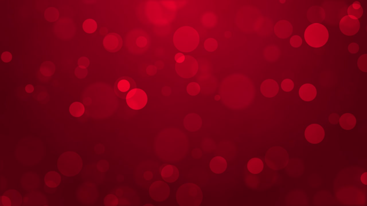 Bolle scintillanti galleggiano su uno sfondo rosso.