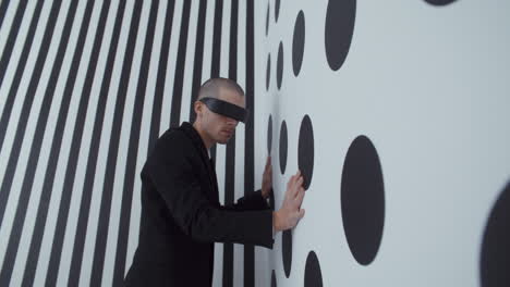 man in vr headset interacting with optical illusion wall