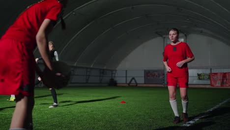 young female soccer players practice indoors